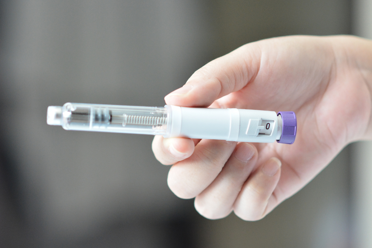 GLP-1 BRIDGE 1 | MedLink Close-up of a hand holding a GLP-1 injector.